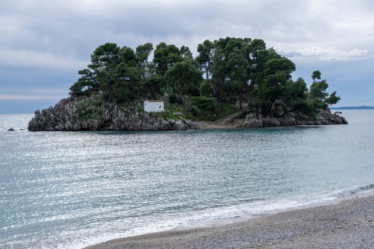Greece Parga. Panagia island off the coast of Parga, small chapel and trees on the rock